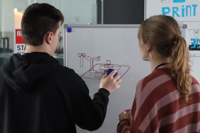 Whiteboarding the robotic arm design at HACK@URI